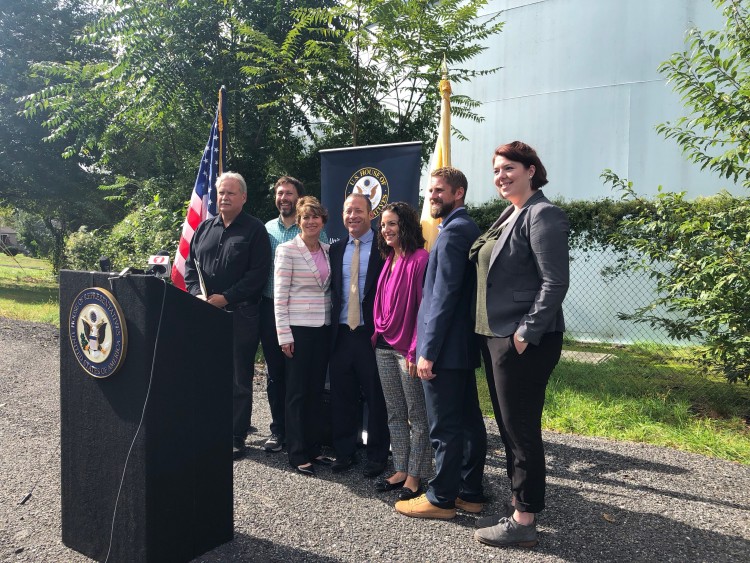Congressman Gottheimer and environmental advocates stand behind the podium at the superfund site.